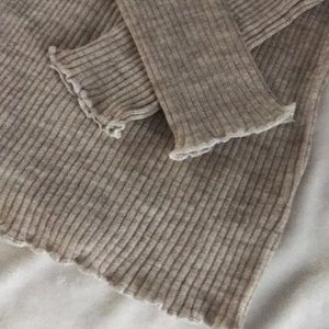 Small oatmeal colored shirt with white frays